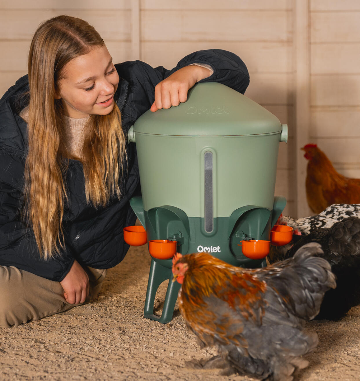 Girl leaning on an anti-topple study chicken waterer