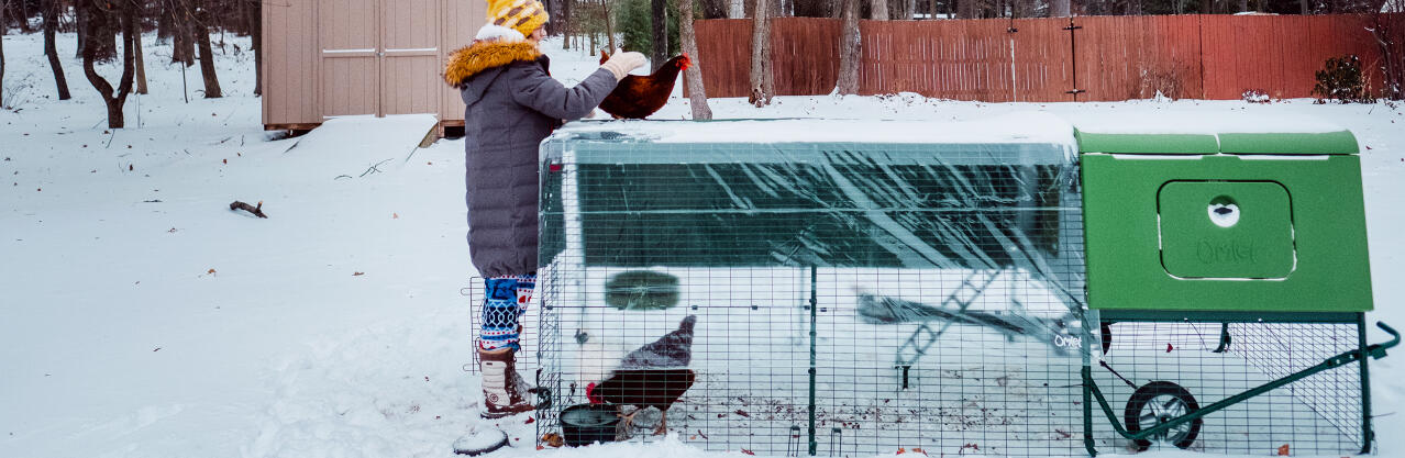 Chicken keeper with the Omlet Eglu Cube in the Snow