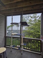 The outdoor freestyle cat tree set up on a deck.