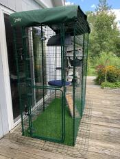 A freestyle cat tree set up in a balcony enclosure.