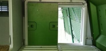 Looking inside an Omlet eglu cube to see the automatic door opener.