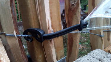 A bungee cord holding on a shade down.
