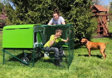 Lady, boy, dog and their Omlet Green Eglu Cube Large Chicken Coop and Run