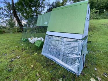 An Eglu Go up chicken coop with clear covers at the back.