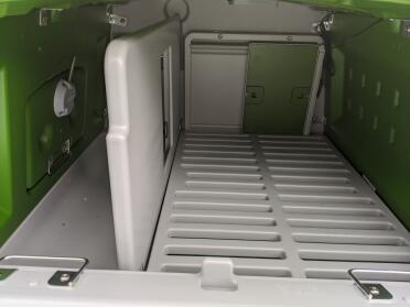 Looking inside an Omlet chicken coop to see the attached automatic door opener.