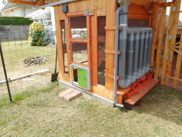 A wooden coop with an automatic door opener retro fitted.