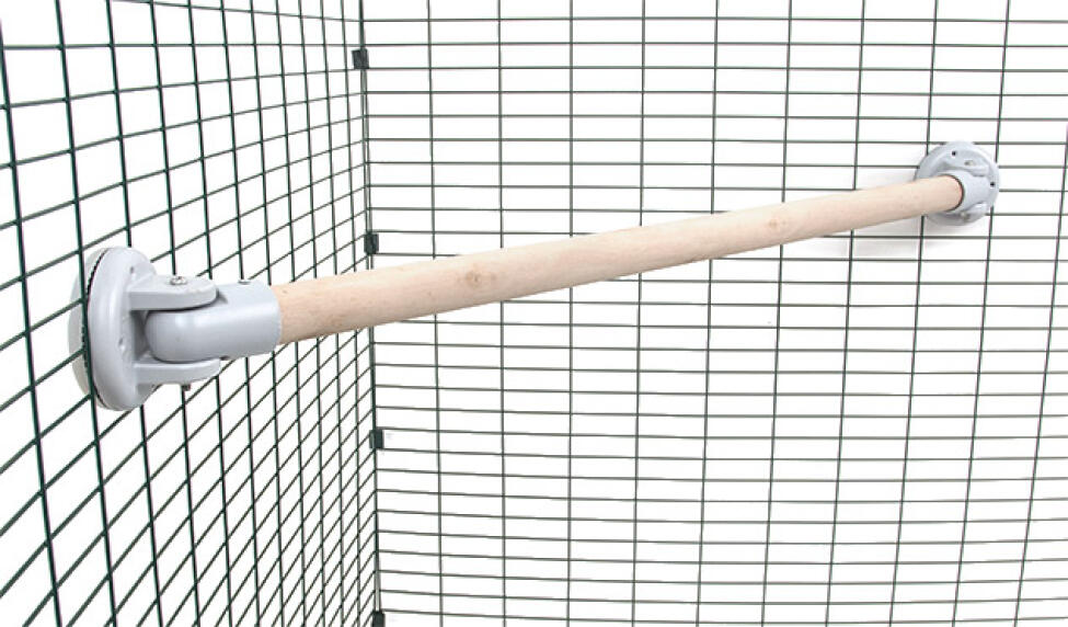 Eine hölzerne sitzstange in einem begehbaren auslauf