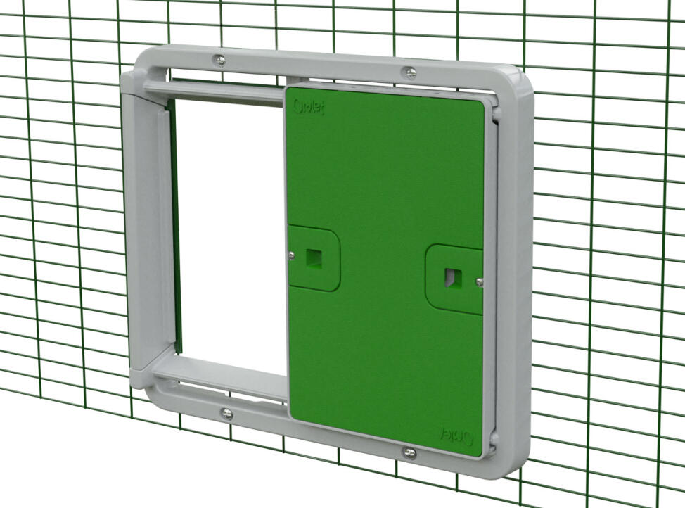 A green Autodoor attached on animal run mesh